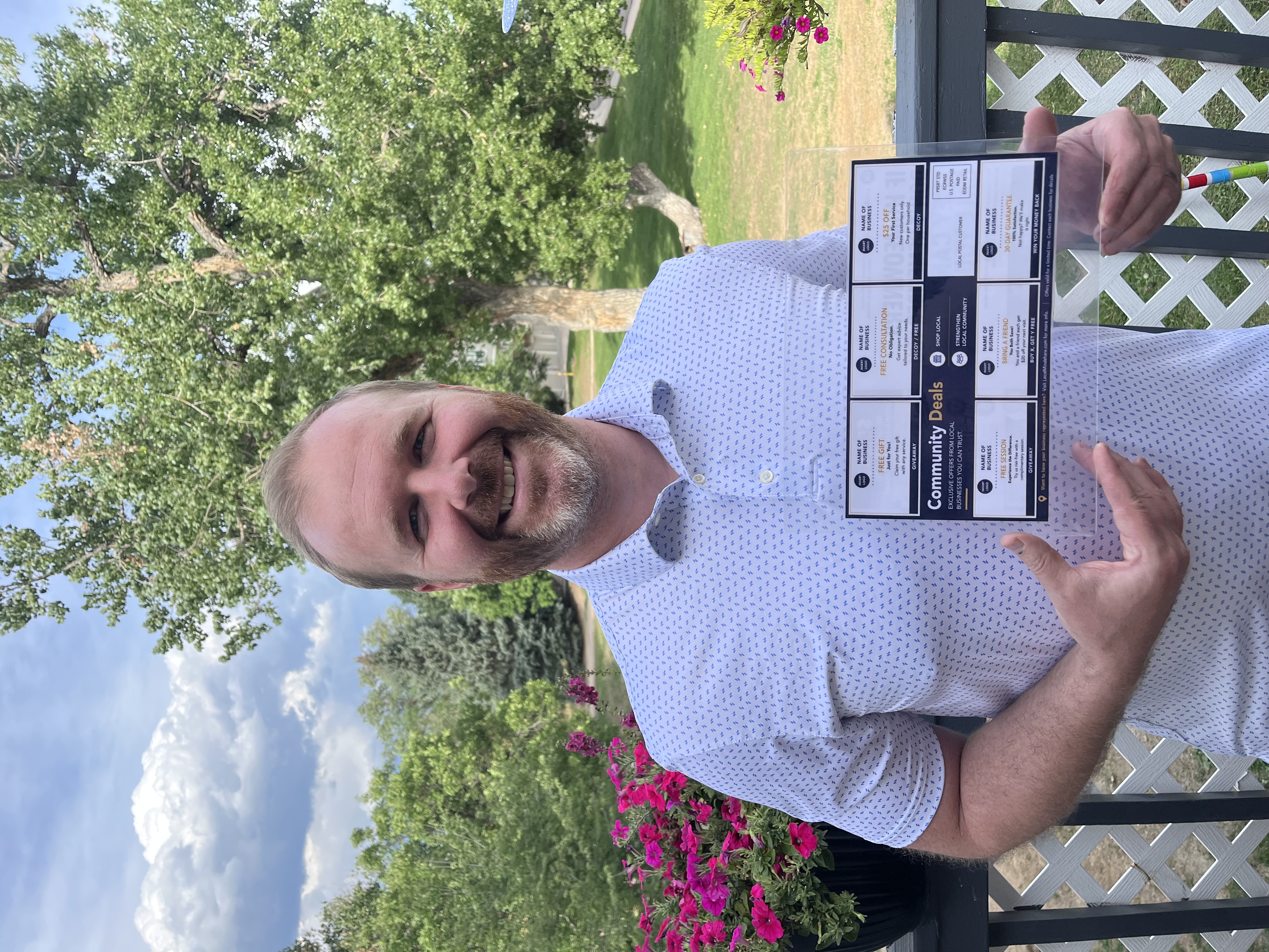 Patrick Mahnke, founder of Local Mindshare, holding a Community Deals mailer